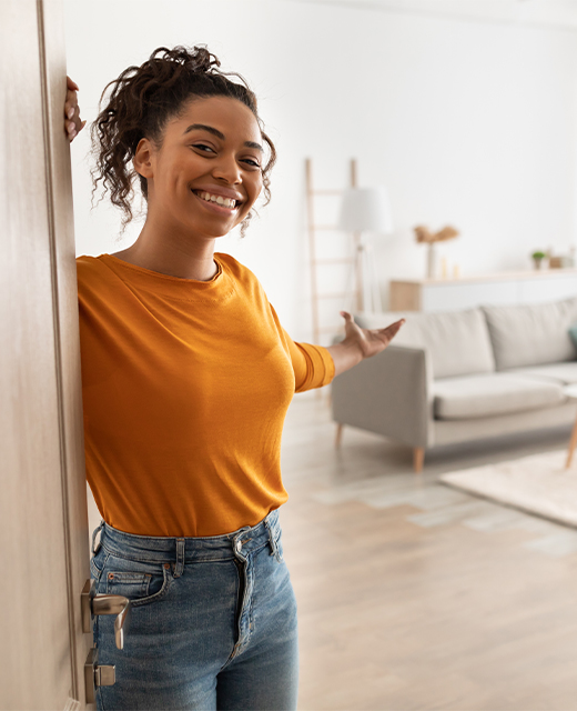 Woman giving a warm welcome to a new neighbor.